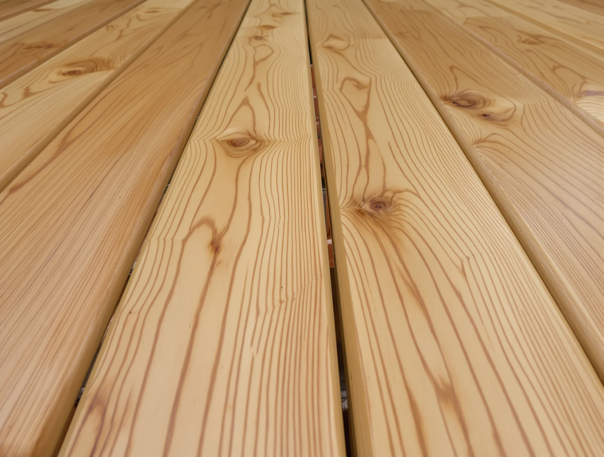 New cedar deck boards with a clear transparent stain showing the full grain